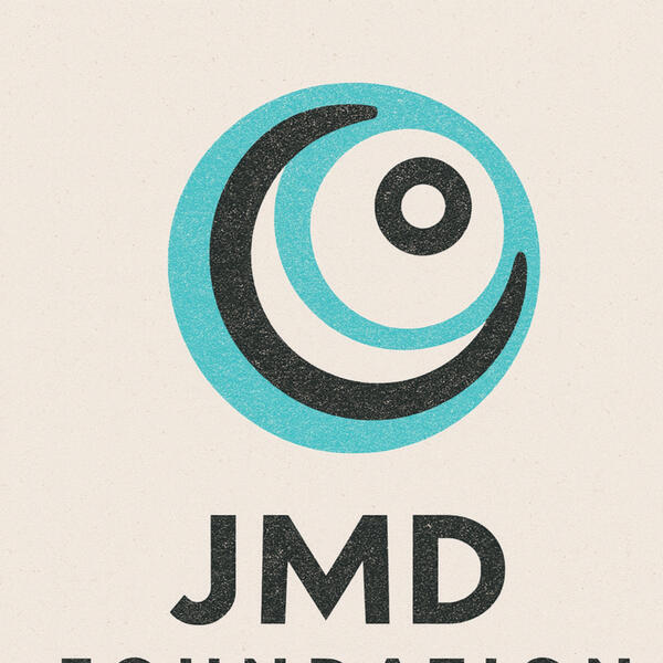 Circular JMD Foundation logo with blue center and orange ring